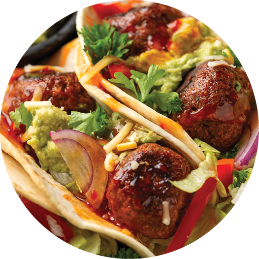 Meat free beetroot and pea protein meatballs taco wraps with avocado guacamole, sweet chilli sauce and lime wedges 