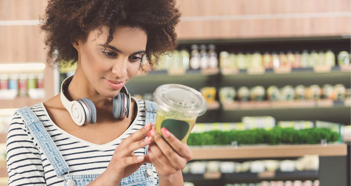 Charming girl is standing in organic shop