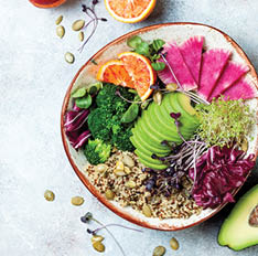 Vegan, detox Buddha bowl with quinoa, micro greens, avocado, blood orange, broccoli, watermelon radish, alfalfa seed sprouts  Top view, flat lay, copy space 