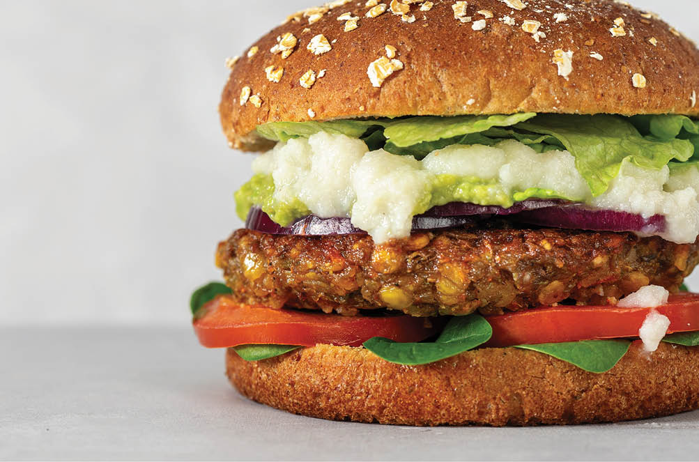 Vegan lentils burger with vegetables on light gray background