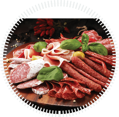 Food tray with delicious salami, pieces of sliced prosciutto crudo, sausage and basil. Meat platter with selection.