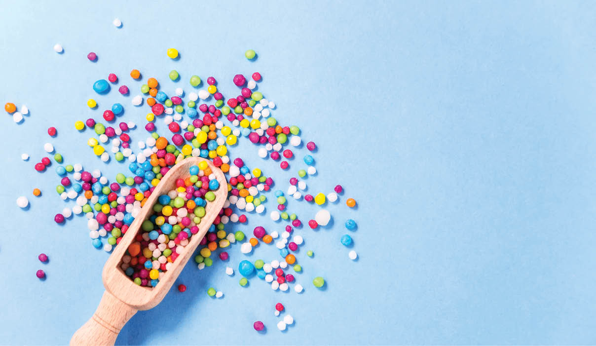 Wood scoop with colorful eatable sugar pearls.Useful for food,sweet background presentation