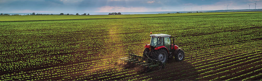 Tractor cultivating field at spring,aerial view