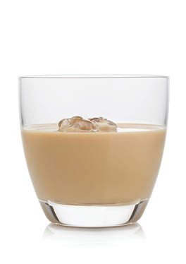 Glass with ice cubes of whiskey and cream based liqueur on white background.