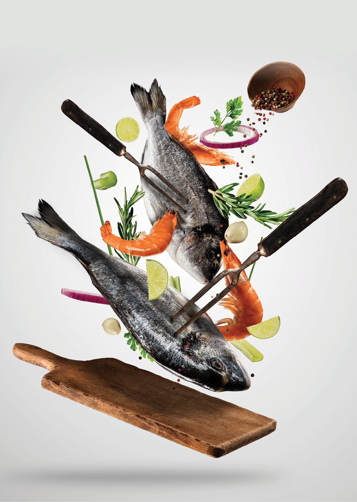 Flying raw whole bream fish and prawns, with ingredients for cooking. Freeze motion. Fork holding the meat. Concept of food preparation in low gravity mode. Separated on smooth gray background