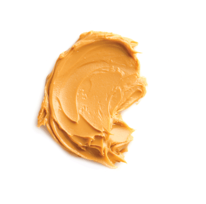Creamy peanut butter on white background