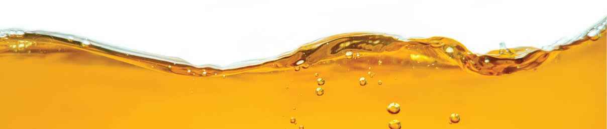 Closeup process of splashing of green tea. Macro shot of liquid in transparent glass. Abstract background with splashes, sprays, waves, bubbles of lager beer, whiskey, cognac, rum, brandy. 