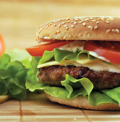 hamburger with cutlet and vegetables on bamboo napkin