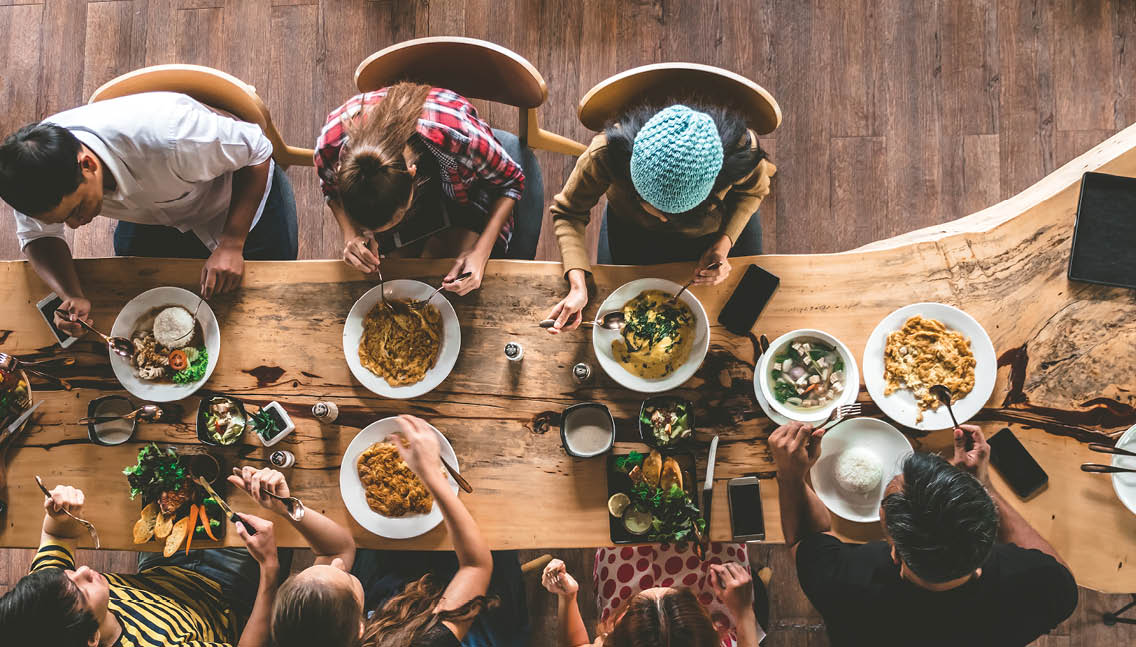 Group of happy friends having nice food and drinks, enjoying the party and communication, Top view of Family gathering together at home for eating dinner.