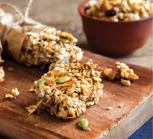 Organic homemade granola bars on rustic wooden background - Healthy vegetarian snack