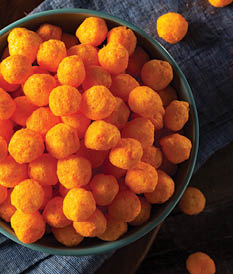 Unhealthy Cheesy Cheese Puffs in a Bowl