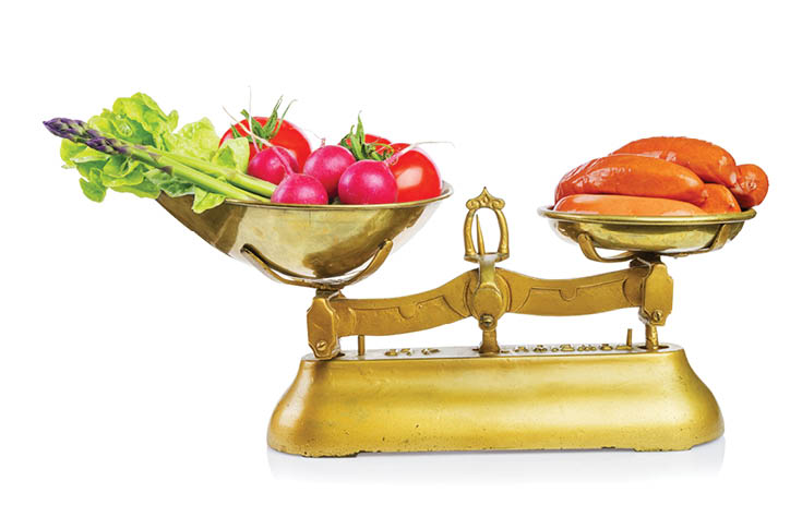 Healthy food and unhealthy food on scales.Dieting concept.Isolated.