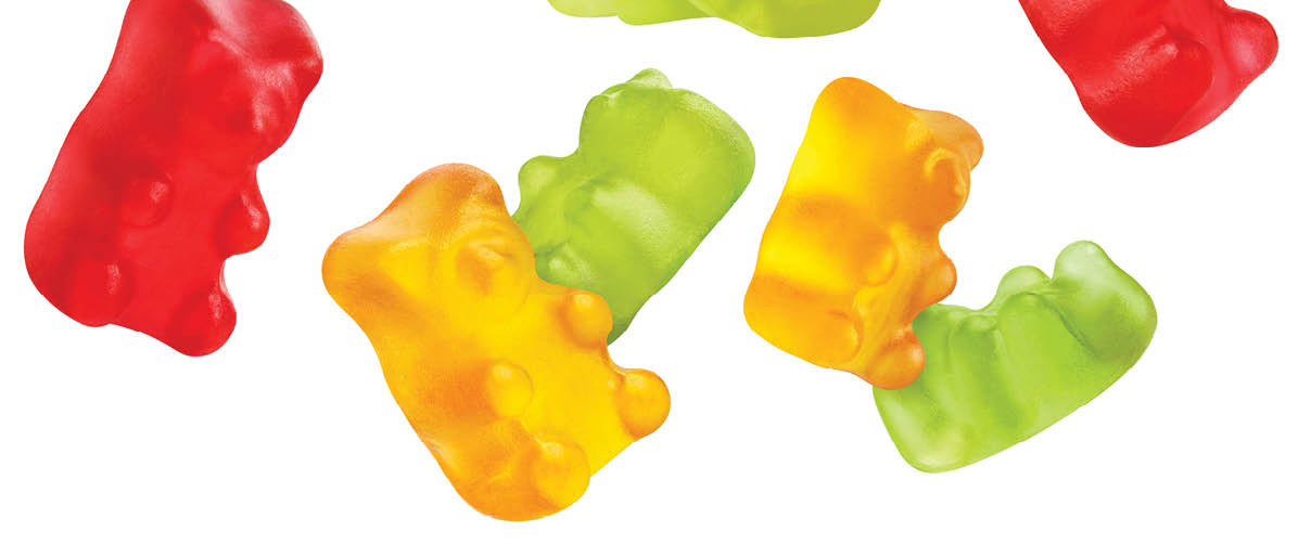 Flying colorful jelly gummy bears, isolated on white background