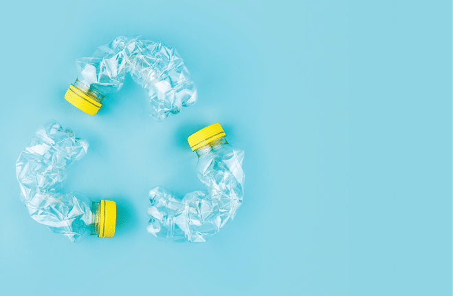 Three crashed plastic bottles on blue background form resycling sign. Plastic utilisation concept. Attractive ecological problem positive poster. 