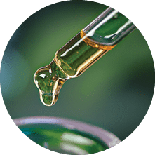 CBD Hemp oil, Hand holding droplet of Cannabis oil against blurry beaker background. Alternative Medicine. droplet dosing a biological and ecological hemp plant herbal pharmaceutical cbd oil.      