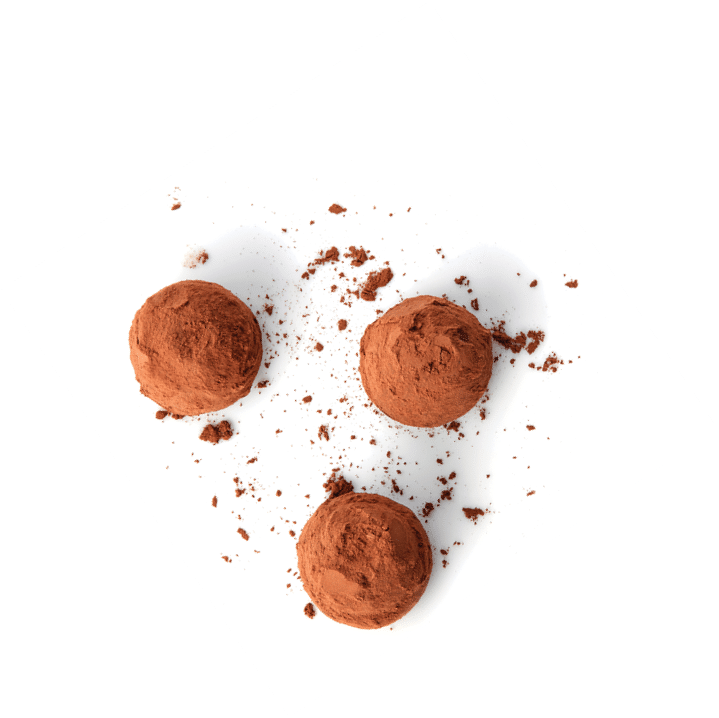 chocolate truffles covered with cocoa isolated on white background, top view