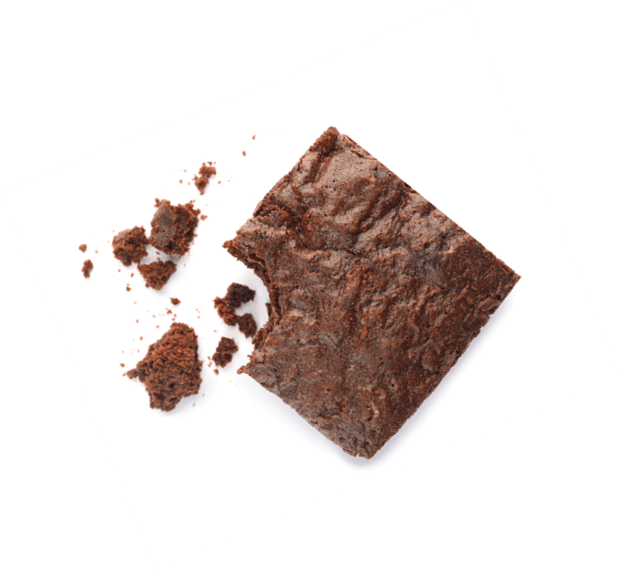 Piece of fresh brownie on white background, top view. Delicious chocolate pie